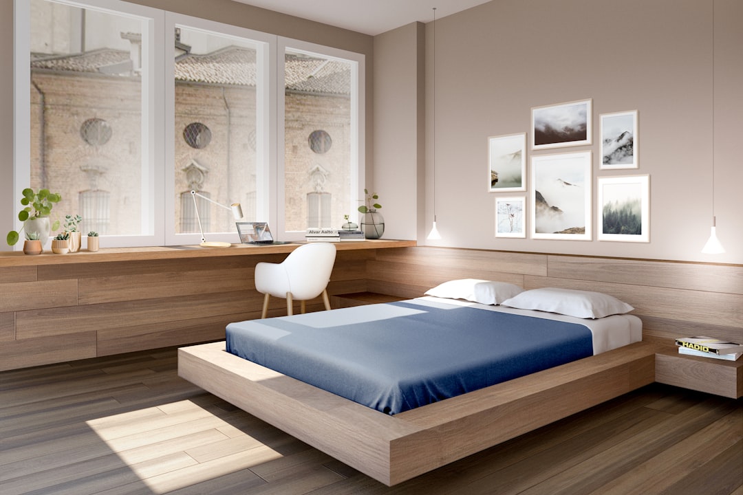 Freshly made new mattress airing out on a bed frame in a sunlit, ventilated bedroom