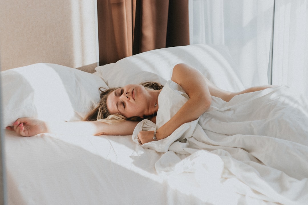 Person sleeping on their stomach on a firm, supportive mattress with the lower back held in neutral alignment