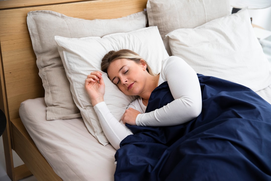 Adult sleeping peacefully in bed at night, illustrating recommended 7 to 9 hours of nightly sleep