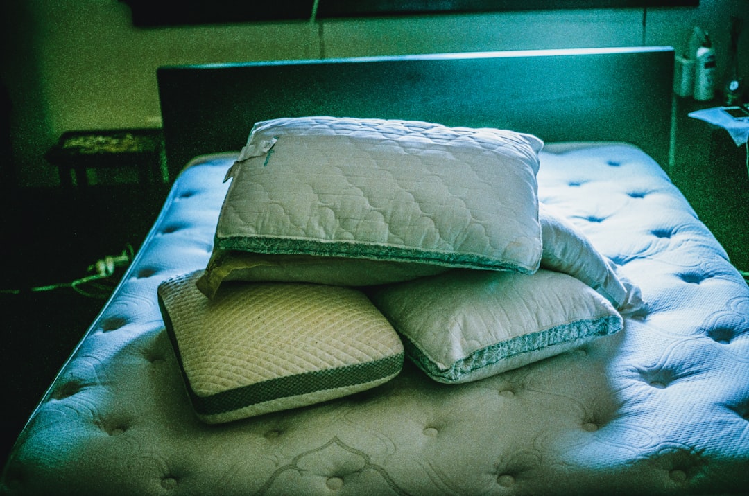 White cooling pillow with a shredded-fill layer and a moisture-wicking cover on a neatly made bed